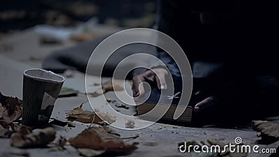 Miserable vagabond holding bible and praying to God, strong belief, faith Stock Photo