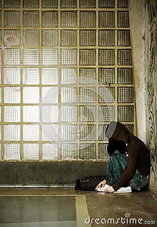 Misfit young girl sitting on the floor Stock Photo