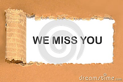 We Miss You the inscription on a torn piece of cardboard Stock Photo