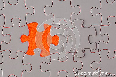 A missing white jigsaw puzzle on shining red Stock Photo