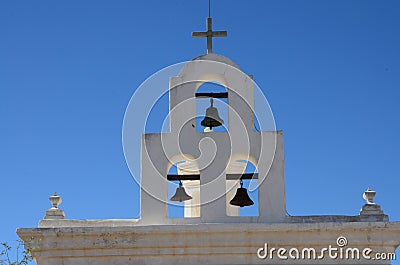 Mission Bells under a Cross Stock Photo