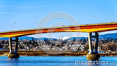 Mission Bridge over the Fraser River on Highway 11 between Abbotsford and Mission with snow covered Mount Robie Reid Stock Photo