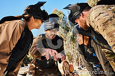 Mission, paintball or people in huddle planning strategy, teamwork or soldier training on war battlefield. Meeting Stock Photo