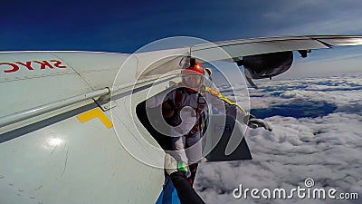 Mission. Parachutist performs an acrobatic trick in the air. Flying men make professional jump. Stock Photo