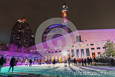 People doing ice skating at Mississauga City Hall Celebration Square Ice Skating Rink in winter night Editorial Stock Photo