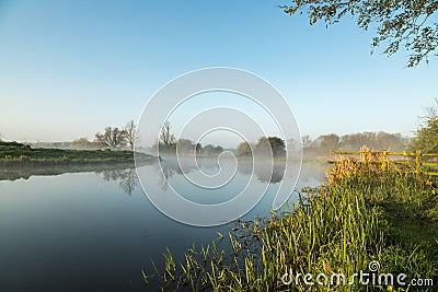 Mist hanging over river Nene in Northamptonshire at sunrise Stock Photo