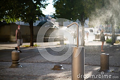 Mist machine installed on a public place to cool down the air. Stock Photo