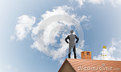 Mister boss on brick roof with arms akimbo. Mixed media Stock Photo