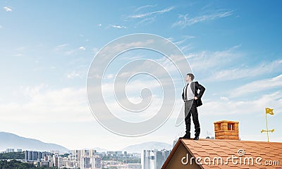 Mister boss on brick roof with arms akimbo. Mixed media Stock Photo