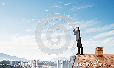 Mister boss on brick roof in search of something new. Mixed media Stock Photo