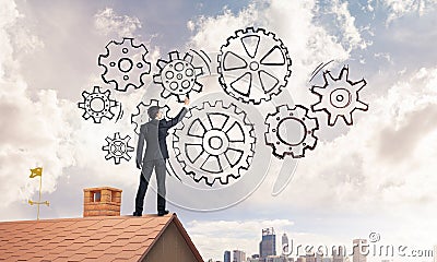 Mister boss on brick roof standing with back and draw teamwork c Stock Photo