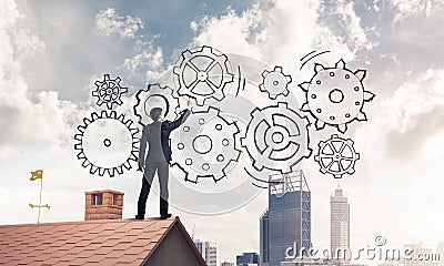 Mister boss on brick roof standing with back and draw teamwork c Stock Photo