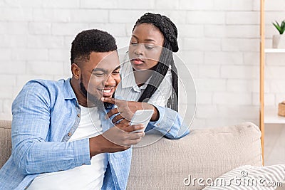 Jealous Wife Peeking How Her Husband Texting On Phone Stock Photo