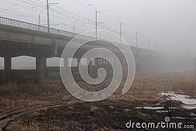 Misty bridge.After the time has elapsed, the density of fog under the bridge is gradually diluted and melts. Stock Photo