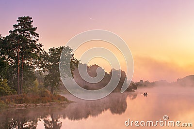 Misty morning on the lake. Fishing boat at a foggy river Stock Photo