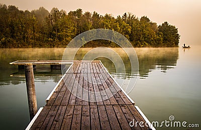 Misty morning pier at the lake Stock Photo