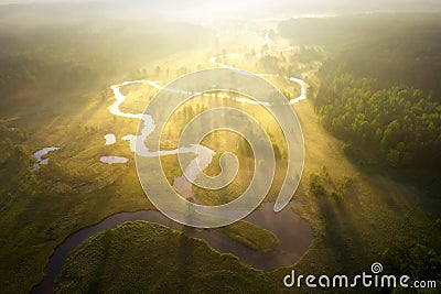 Misty morning river in sunlight. River landscape aerial view. Riverside view from above. Summer nature in sun rays. Drone view on Stock Photo