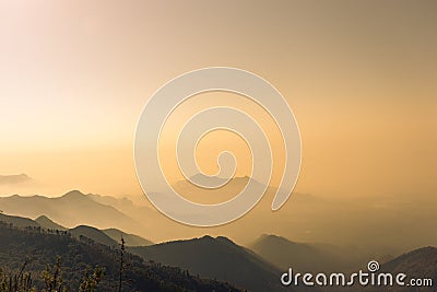 Misty mountains orange sun rays view Stock Photo