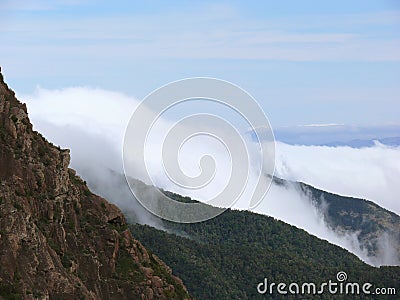 Misty Mountains Under a Blue Sky Stock Photo