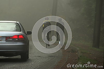 Misty road cyclists Stock Photo