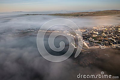 Misty sunrise over the rocky coast of Kilkee, Co. Clare. Ireland Stock Photo
