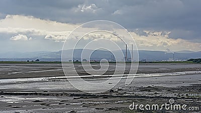 Misty view from across the water on Poolberg peninsula, with the chimneys of the power generation station , view from the beach Editorial Stock Photo