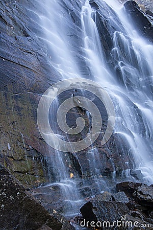 Misty water cascading over rocks Stock Photo