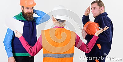 Misunderstanding concept. Builders and engineer arguing, misunderstanding. Stock Photo