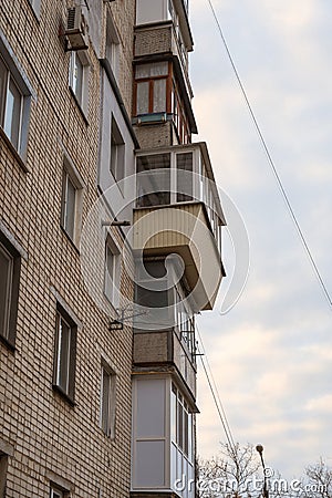 Misunderstood balconies on the wall of the apartments. Different in shape, size, material and construction balconies one above the Stock Photo