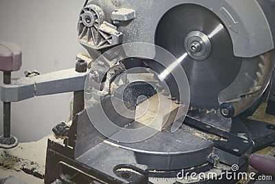A miter saw making a compound cut through construction lumber Stock Photo