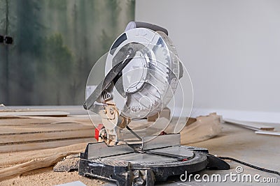 The miter saw or a multi material construction saw on the floor of the apartment Stock Photo
