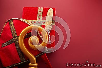 Mitre or mijter staff and book of Sinterklaas on red backgroud. Dutch santa tradition. Stock Photo