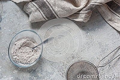 Mix for baking with bird cherry flour in a transparent bowl on a concrete tabletop background. Culinary cover, ingredient Stock Photo