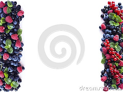 Mix berries and fruits at border of image with copy space for text. Ripe blueberries, blackberries, black currants and raspberries Stock Photo