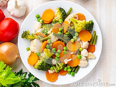 Mix of boiled vegetables, steam vegetables for dietary low-calorie diet. Broccoli, carrots, cauliflower, top view Stock Photo