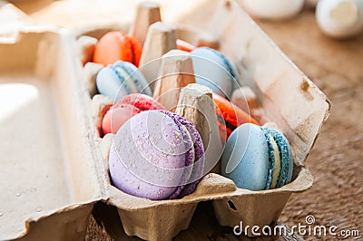 Mix of colorful macarons in a craft paper egg container Stock Photo