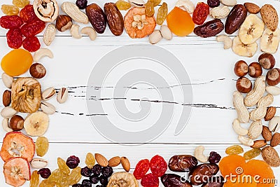 Mix of dried fruits and nuts on a white vintage wood background with copy space. Top view. Symbols of judaic holiday Tu Bishvat. Stock Photo