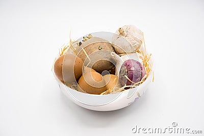 Mix of egg potato onion and garlic on the nest with white background Stock Photo