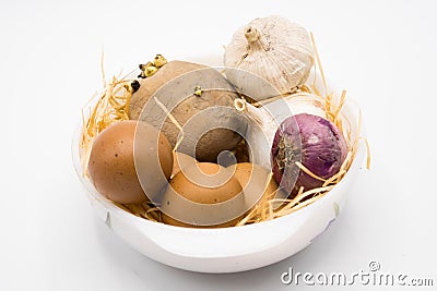 Mix of egg potato onion and garlic on the nest with white background Stock Photo