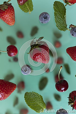 Mix of flying berries on a blue background, Stock Photo