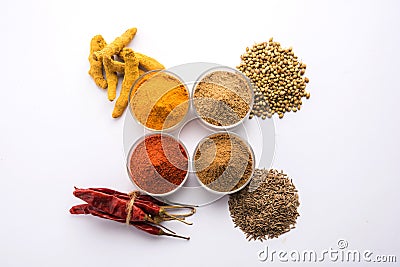 Indian Raw Spice Powder in white bowls over red or yellow or green background, selective focus Stock Photo