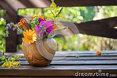 Mix of medicinal herbs in a mortar in a garden Stock Photo