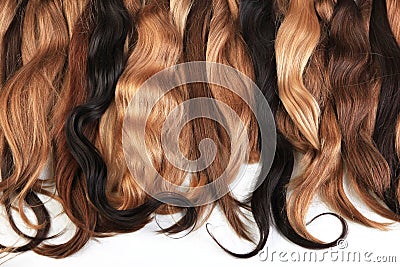 Mix of natural extensions hair: blond, red, brown. Strands of ha Stock Photo