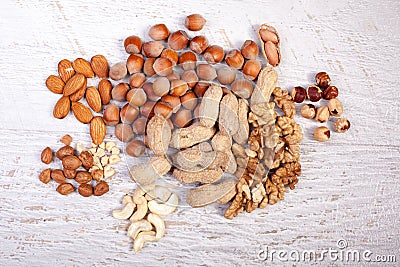 Mix of variety of nuts on white wooden background Stock Photo