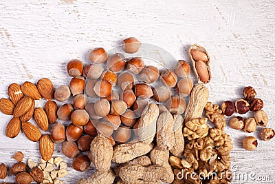 Mix of variety of nuts on white wooden background Stock Photo