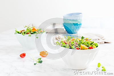Mixed baby greens and cherry tomatoes salad in bowl. Superfood s Stock Photo