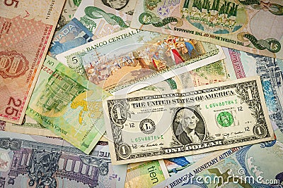 Mixed bills from around the world with the dollar bill in a prominent position Stock Photo