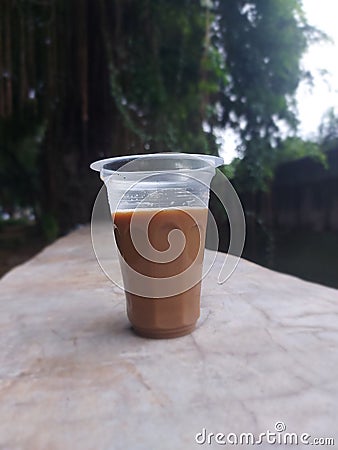 Mixed coffee drink in aqua glass. Looks beautiful taken on the edge of a ditch at Tanjung Duren Park, West Jakartaï¿¼ Stock Photo
