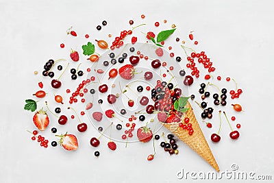 Mixed colorful berries in waffle cone on white table top view in flat lay style. Stock Photo