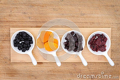 Mixed dried fruit and berries in ceramic ramekins Stock Photo